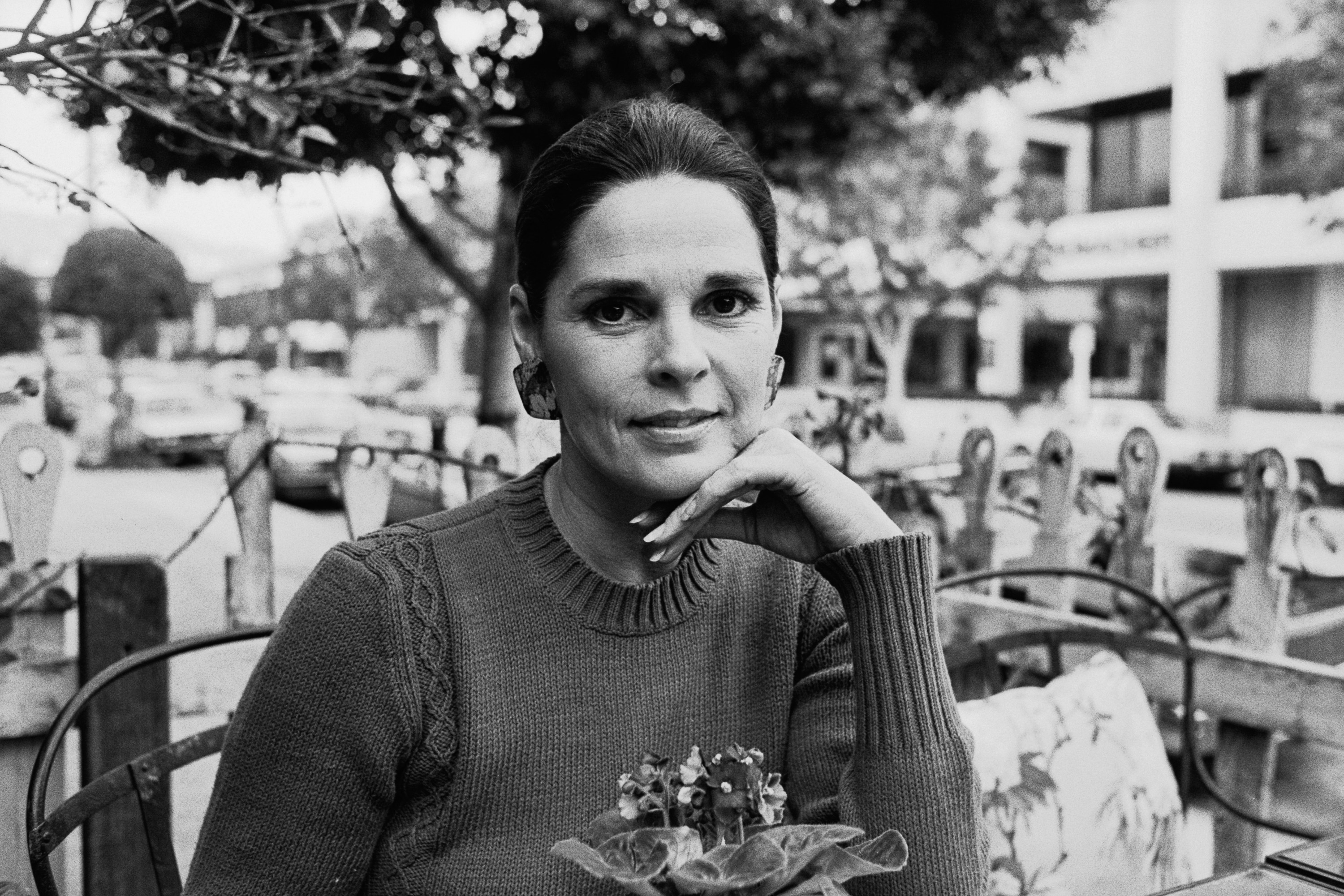 Ali MacGraw poses in a black and white image.