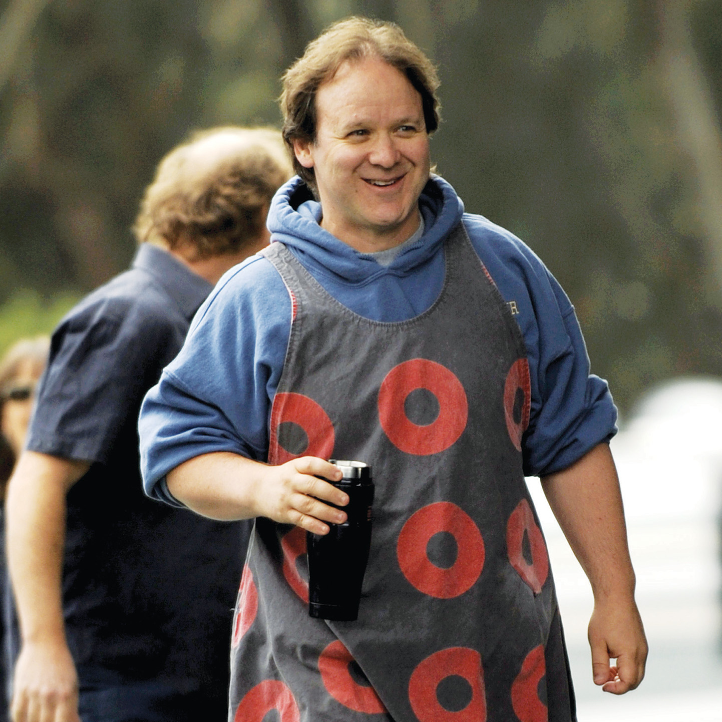 Jon Fishman wearing a dress with a donut pattern on it